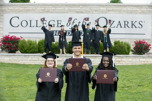 Students holding diplomas 